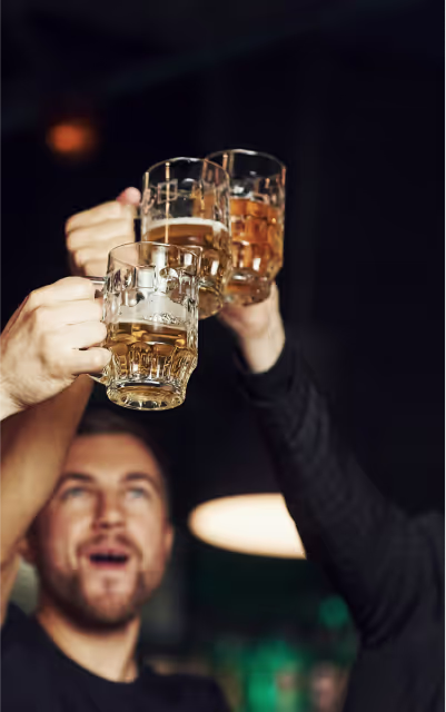 A group of men cheering with beer glasses